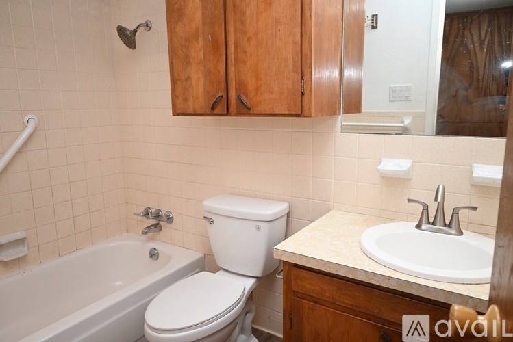 A bathroom with a toilet, sink, and bathtub.