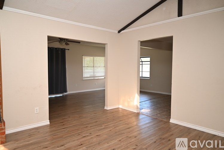 A room with wooden floors and a ceiling fan.