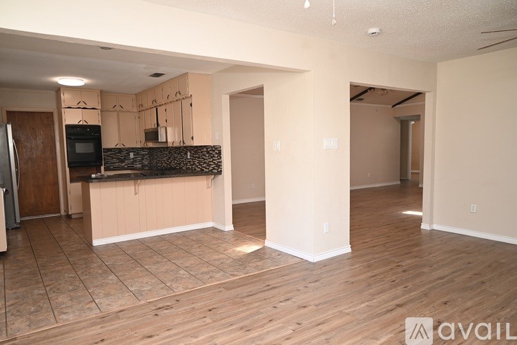 A kitchen area with a microwave, oven, and cabinets.