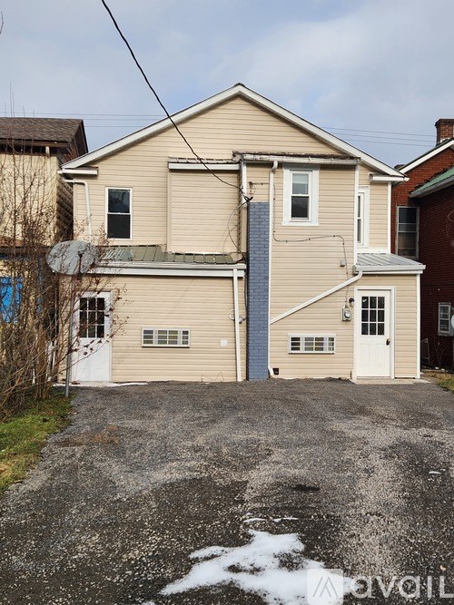 A two-story house with a garage and satellite dish.