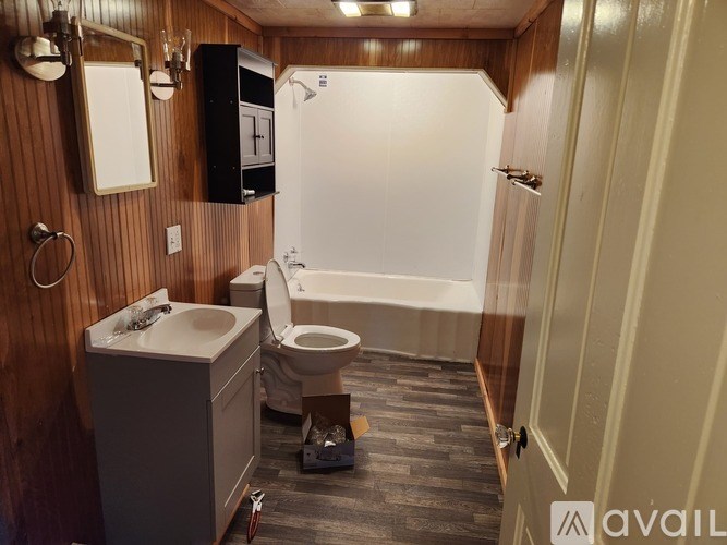 A bathroom with a toilet, sink, and bathtub.