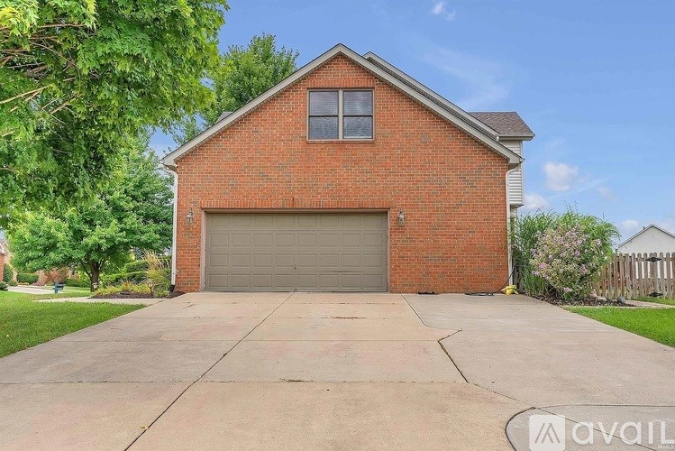 A red brick house with a grey garage door.
