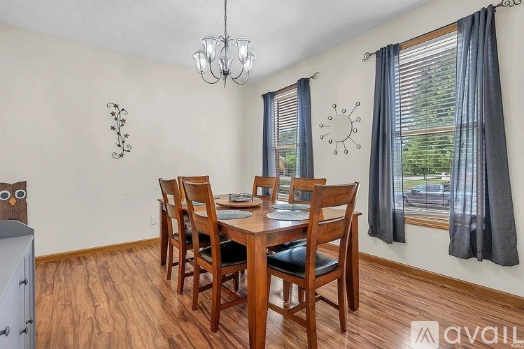 A dining room with a wooden table and chairs.
