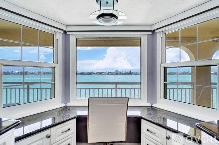 A kitchen with a view of the water.