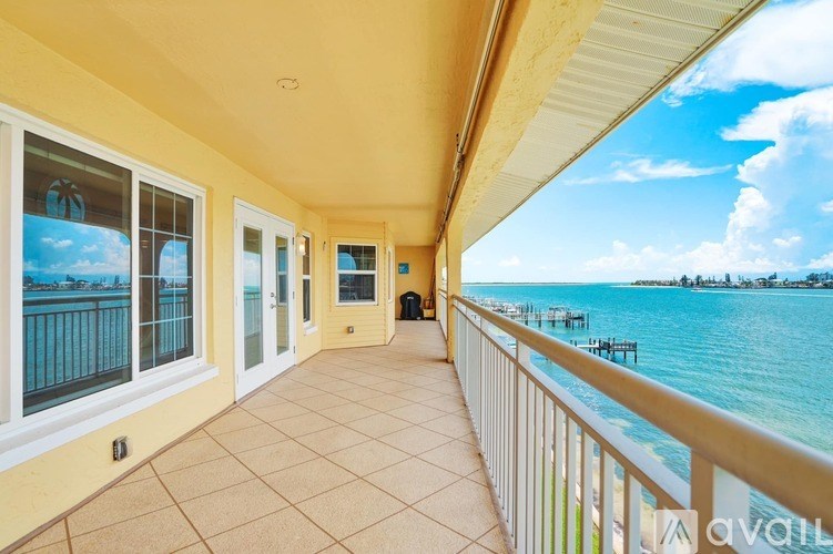 A balcony with a view of the water and sky.