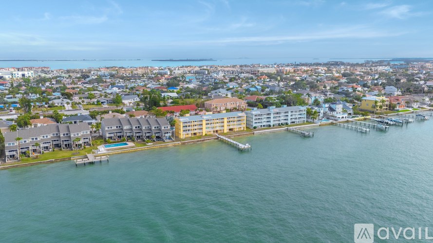 A bird's eye view of a coastal city with buildings and a body of water.