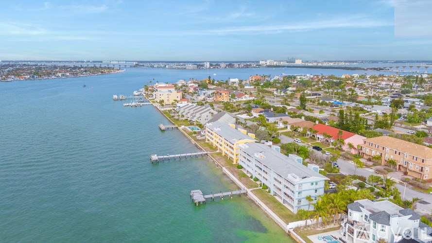 A coastal city with buildings and a pier.