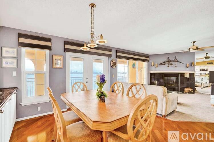 A dining room with a wooden table and chairs.