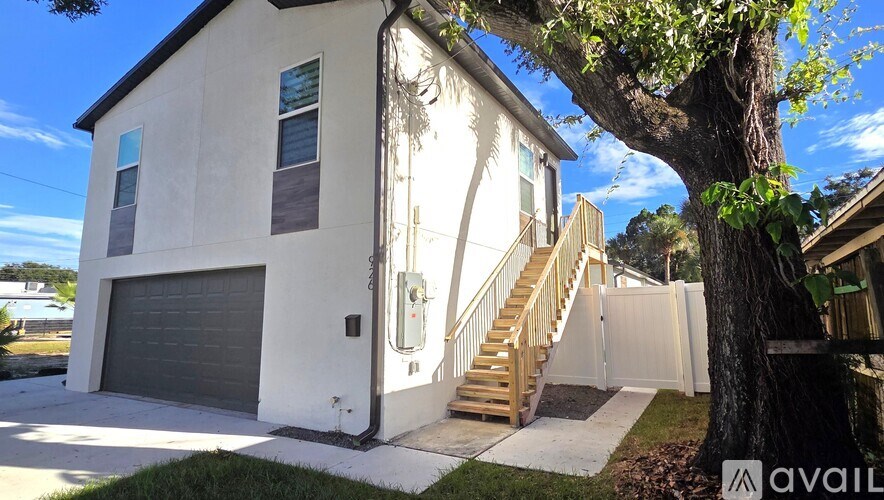 A house with a tree in front of it.