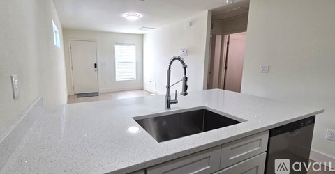 A kitchen with a sink and a dishwasher.