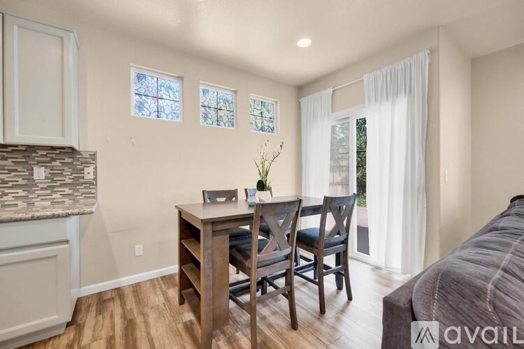 A bedroom with a bed, table, and chairs.