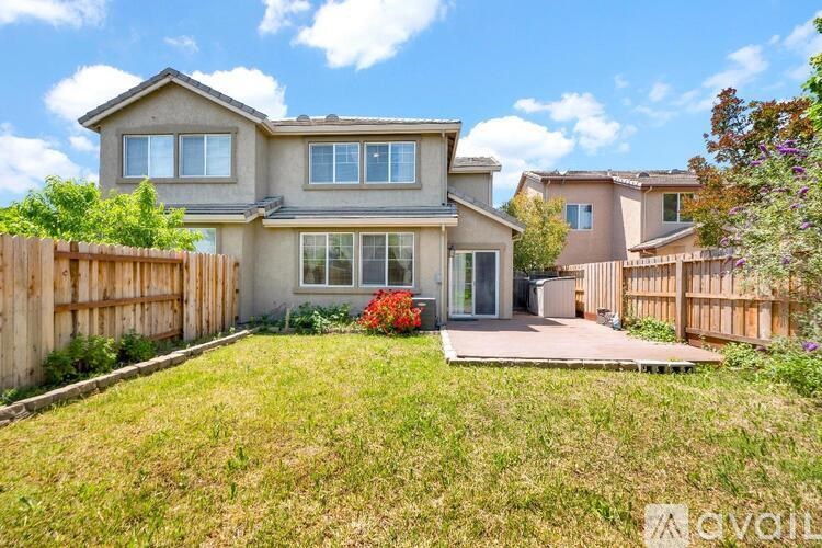 A house with a fence and a garden in front.