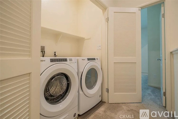 A laundry room with two front-loading washing machines.