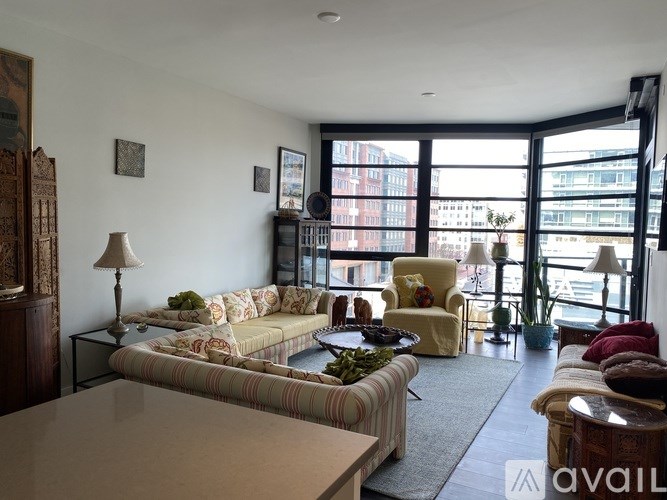 A living room with a striped couch and a coffee table.