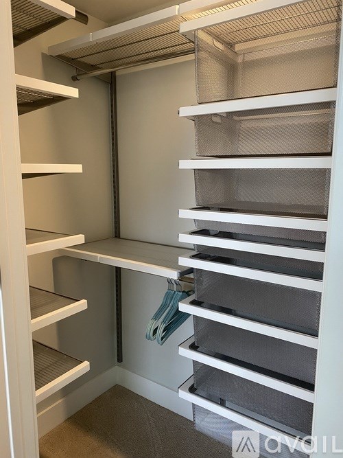 A white refrigerator with a few items inside.