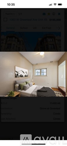 A bedroom with a bed, nightstand, and window.