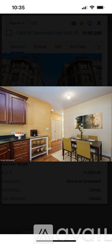 A kitchen with wooden cabinets and a dining area with a table and chairs.