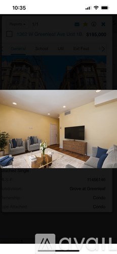 A living room with a large flat screen TV and a coffee table.