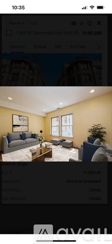 A living room with a couch, a coffee table, and a plant.