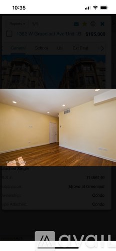 A room with wooden flooring and a white door.