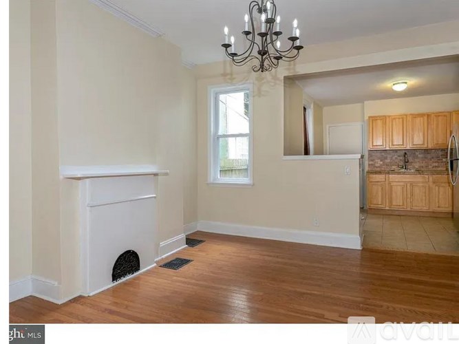 A room with a fireplace and a chandelier.