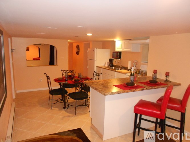 A kitchen with a table and chairs in the middle.