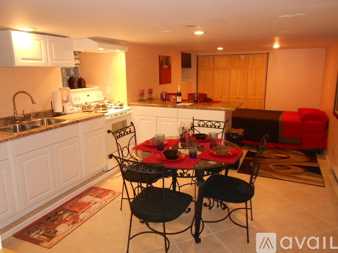 A kitchen with a table set for a meal.