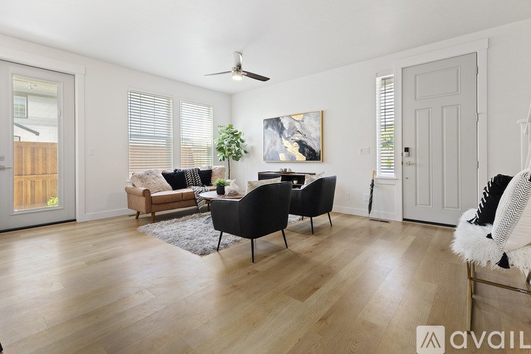 A living room with a black chair and a white chair.