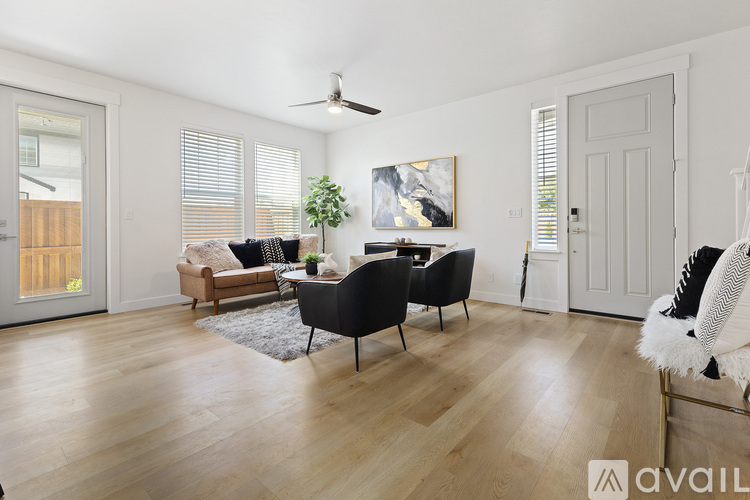 A living room with a black chair and a white chair.