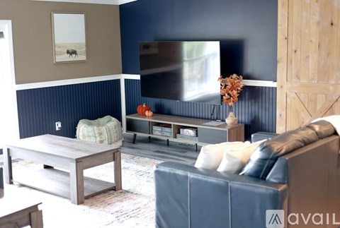A living room with a grey couch and a wooden coffee table.
