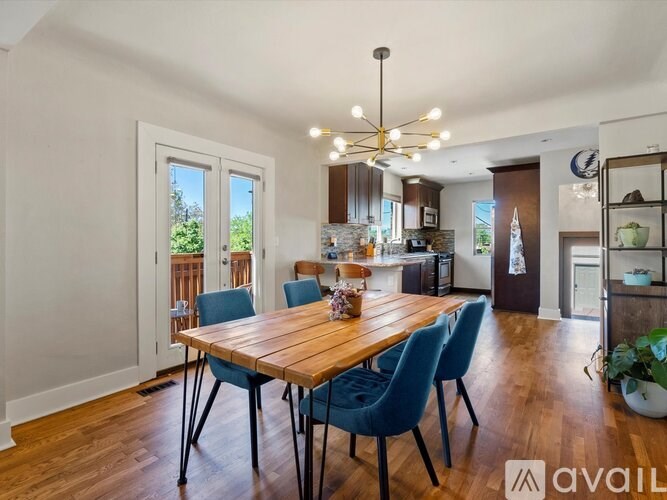 A dining room with a wooden table and blue chairs.