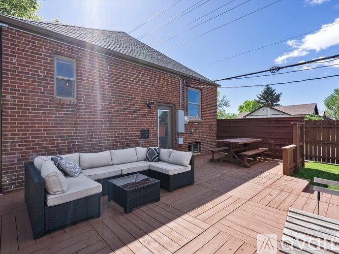 A patio with a white couch and a black coffee table.