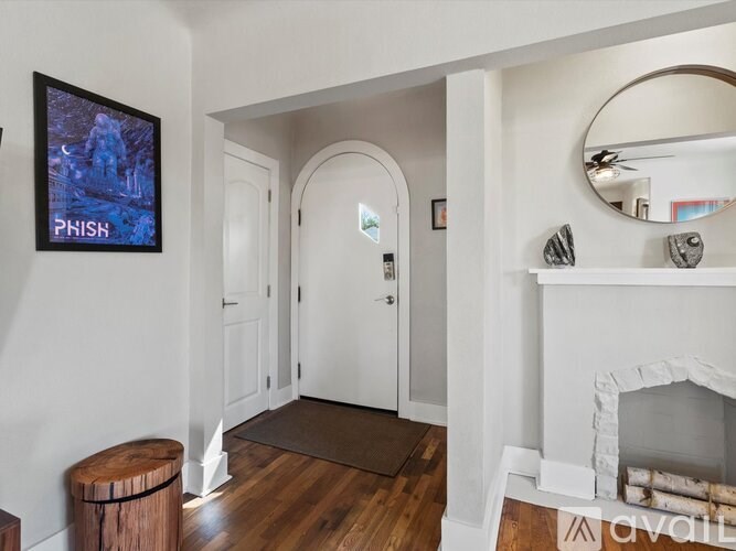 A living room with a fireplace and a TV mounted on the wall.