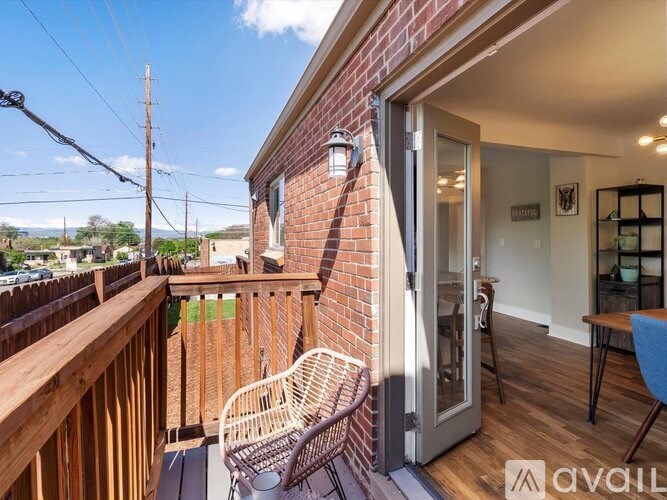 A balcony with a chair and a table is shown.