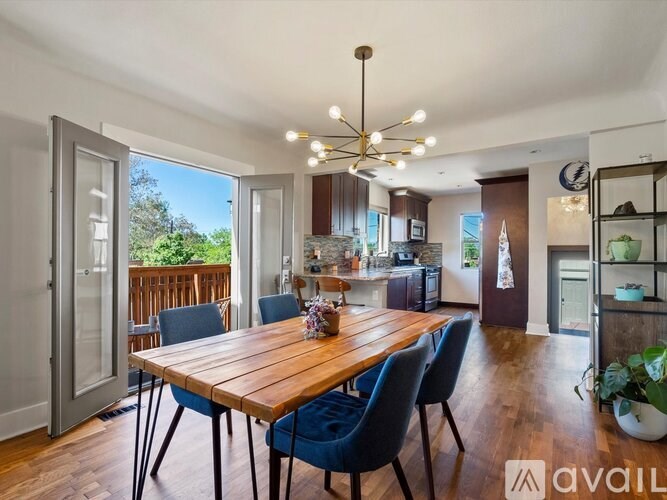 A dining room with a wooden table and blue chairs.