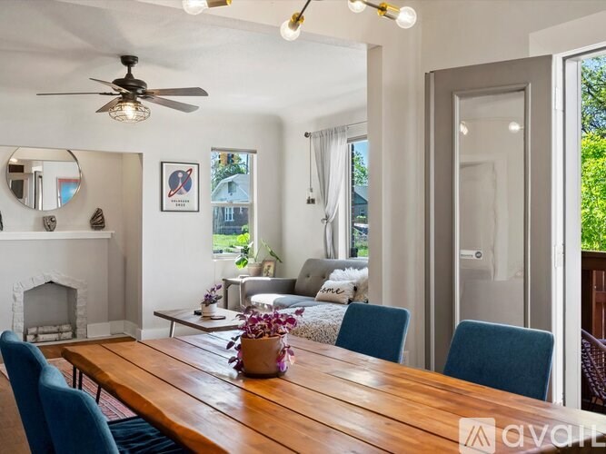 A dining room with a wooden table and blue chairs.