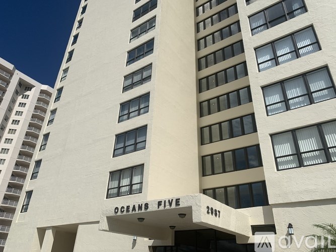 A tall white building with the words "Oceans Five" on the front.