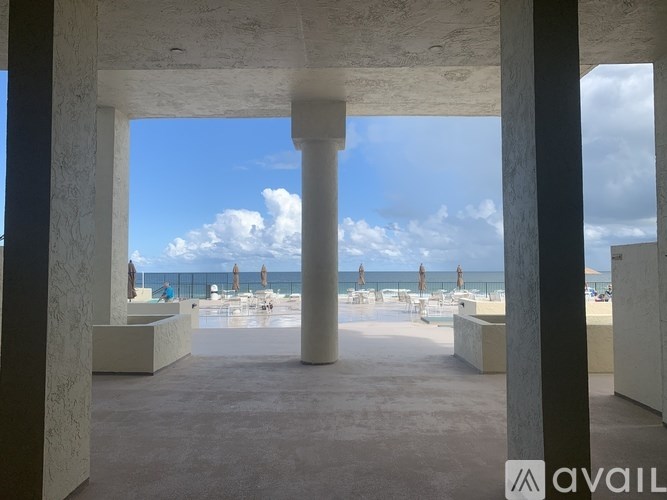 A view of a beach through an open doorway.