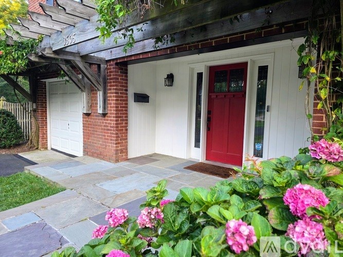 A house with a red door and a white garage door.