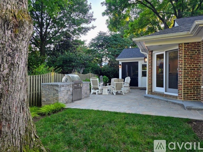 A backyard with a patio and a small house.