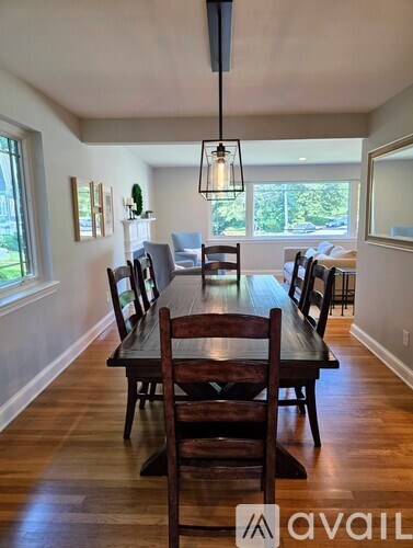 A dining room with a long table and chairs.