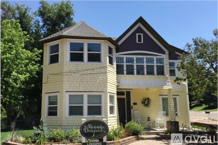 A two story building with a sign in front that says "Aragon Dragonfly Lodging".