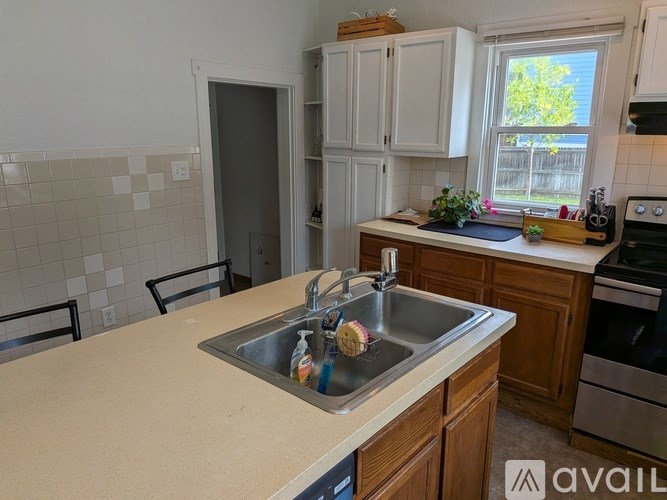 A kitchen with a sink and a window.