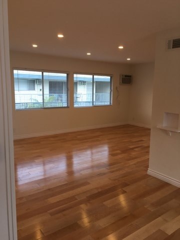 A room with wooden floors and windows.