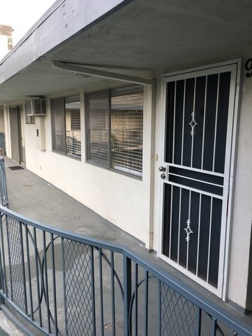 A white door with a black handle and window with blinds.