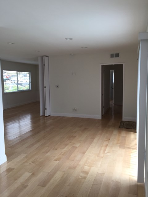 A room with wooden floors and white walls.