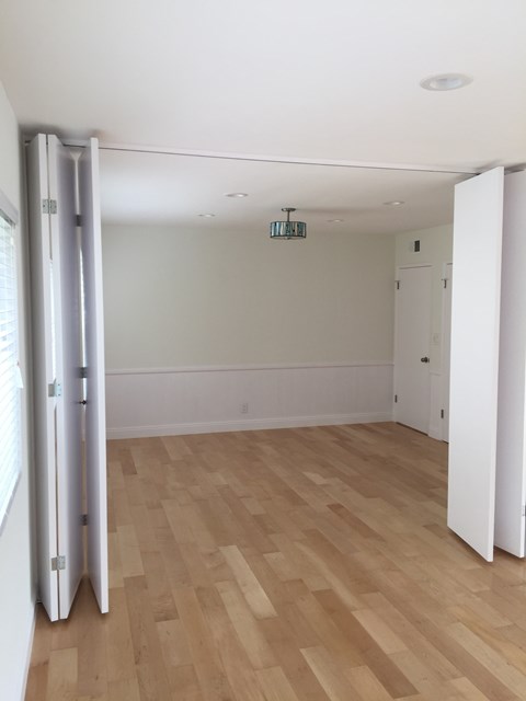 A room with a white door and a white wall.