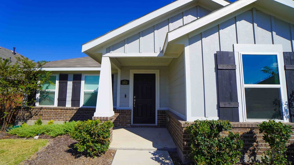 A house with a white front door and a small porch.