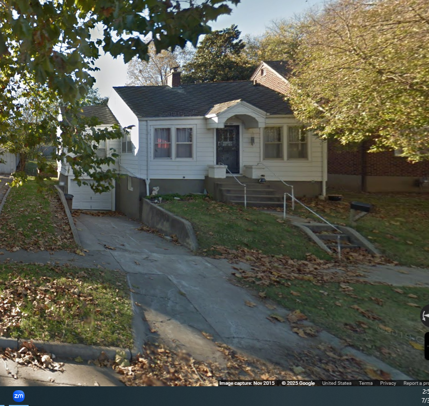A house with a grey roof and a white front door.