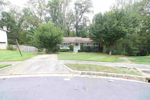 A residential area with a house and trees.